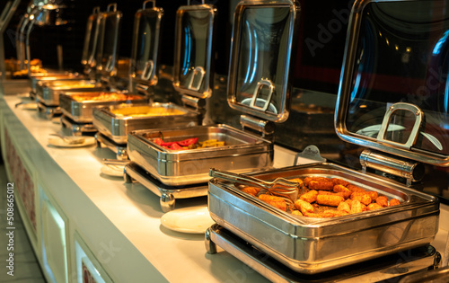 All-inclusive buffet food in heating trays in hotel restaurant