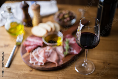 italian antipasto plate with glass of red wine