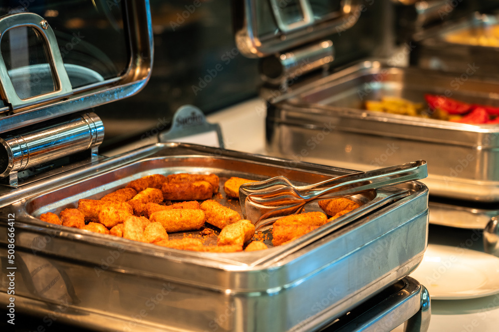 Heated buffet containers with potato sticks for breakfast in hotel restaurant Heated buffet containers with potato sticks for breakfast in hotel restaurant