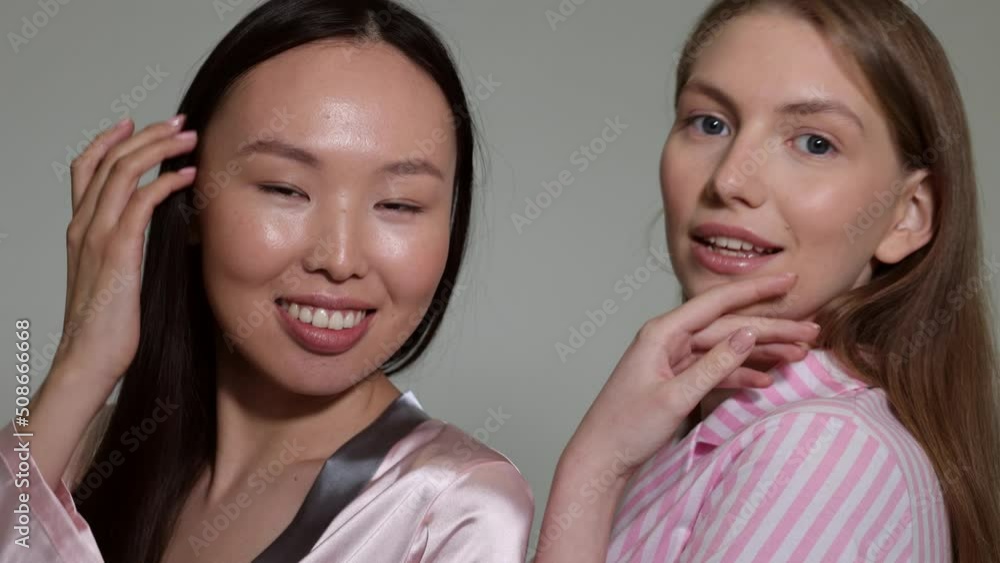 Two young ladies showing patches under eyes. Closeup of ideal beautiful woman faces. Young women portrait with transparent hydrogel eye pads. Diversity of nationalities Two young ladies showing patches under eyes. Closeup of ideal beautiful woman faces. Young women portrait with transparent hydrogel eye pads. Diversity of nationalities