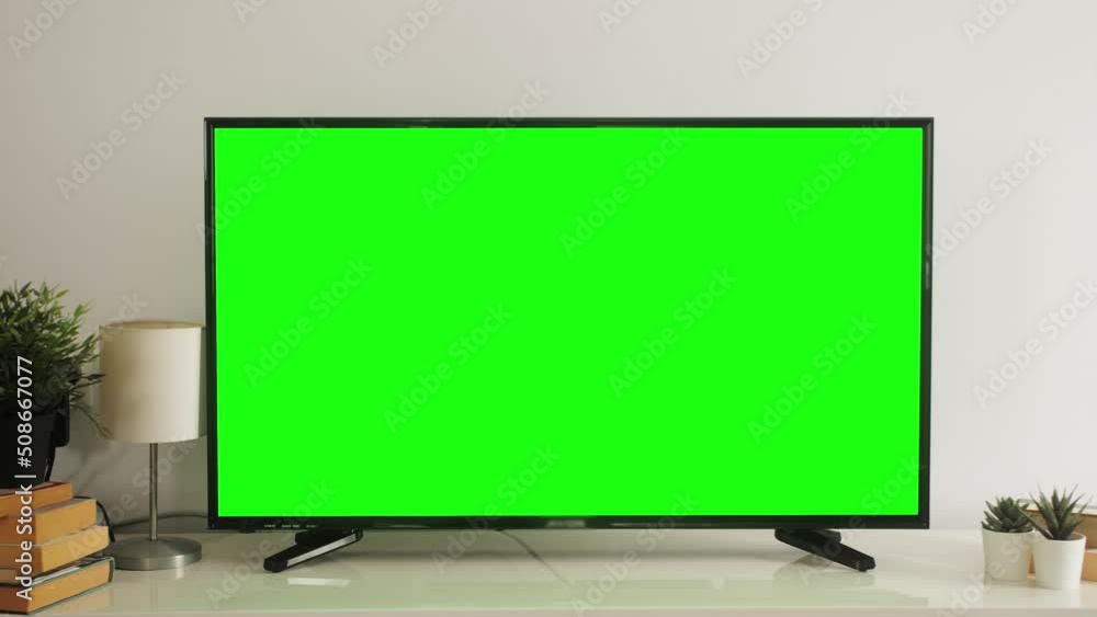 LSD smart TV screen with a blank green background in the living room. Chroma key screen for advertising.