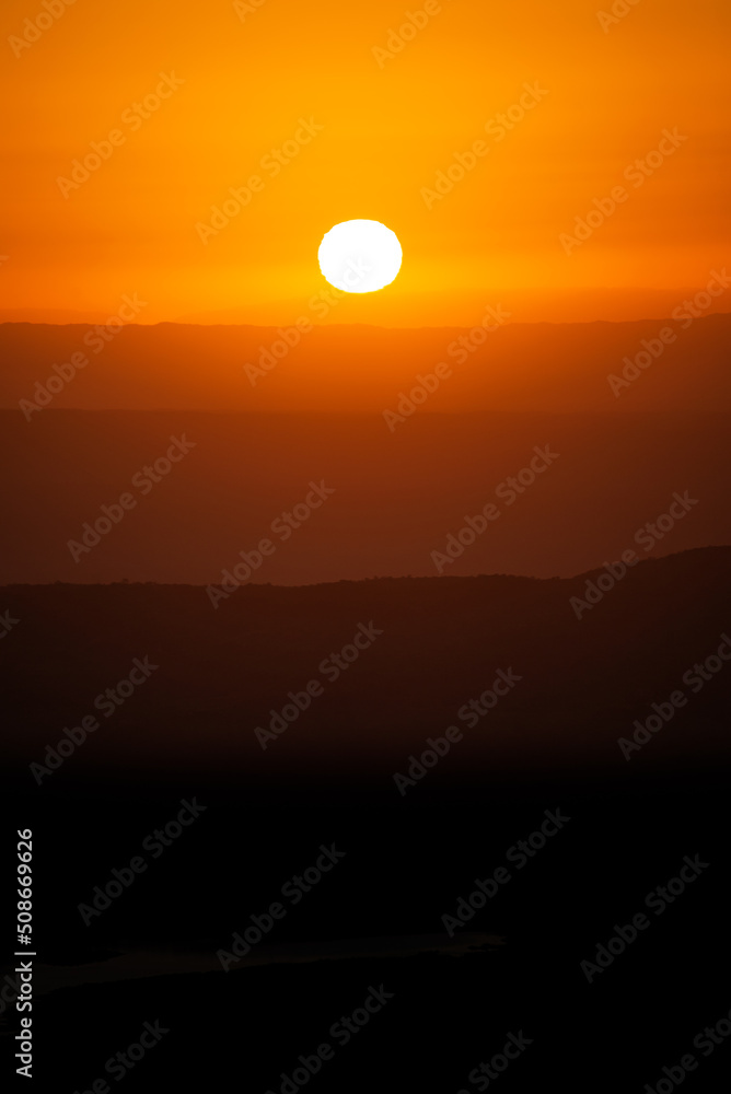 View of Mountains Ridges Layers with White Sun at Sunset Time in Cordoba,Argentina.Vertical Image View of Mountains Ridges Layers with White Sun at Sunset Time in Cordoba,Argentina.Vertical Image