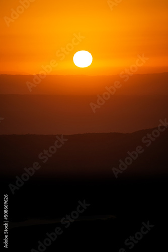 View of Mountains Ridges Layers with White Sun at Sunset Time in Cordoba,Argentina.Vertical Image © nicolas