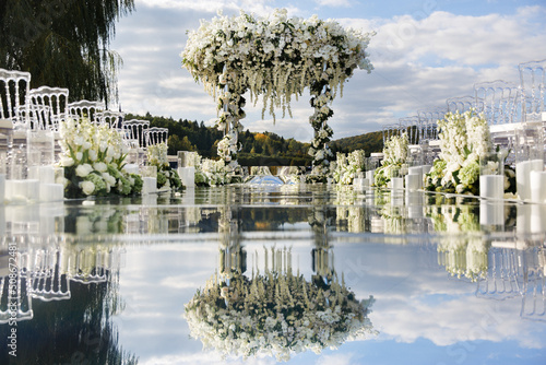 Outdoor wedding ceremony by the lake near the forest