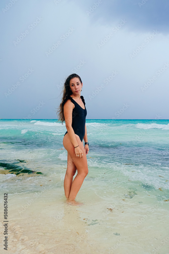 sexy latina girl posing in the caribbean beach of mexico