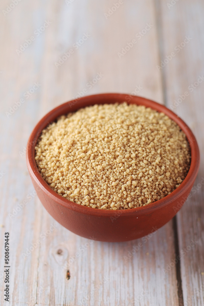Dry couscous in a small ceramic bowl Dry couscous in a small ceramic bowl