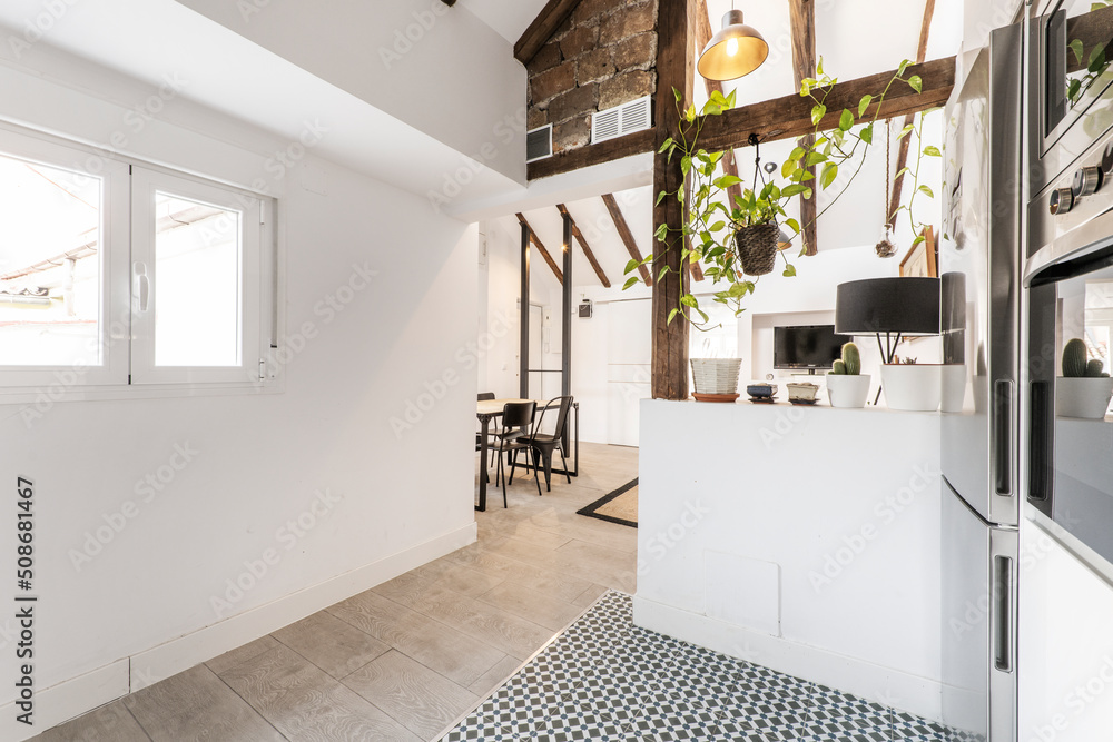 Image showcasing penthouse with high ceilings, updated vintage wood beams, white kitchen ...