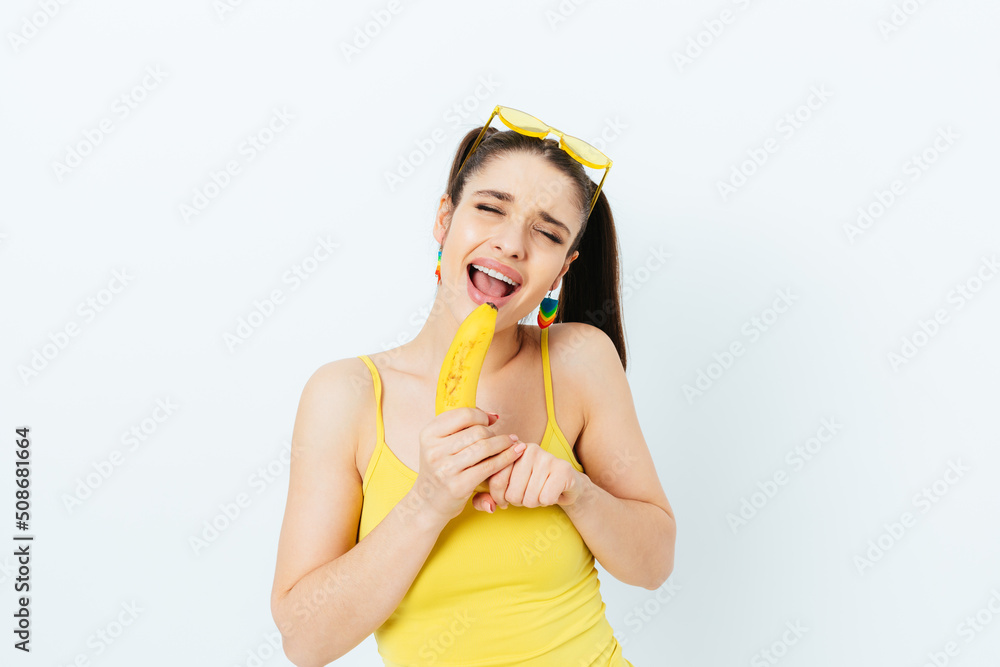 Enthusiastic happy young woman having fun sing holding banana Enthusiastic happy young woman having fun sing holding banana