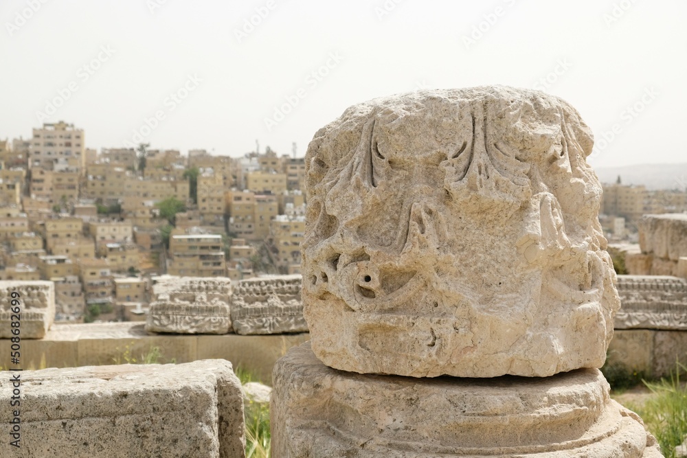 Details of ruins of Temple of Hercules in Citadel Jebel Al Qala'a in Amman, Jordan. Panorama of city in background.