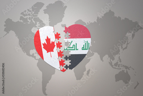 puzzle heart with the national flag of canada and iraq on a world map background.Concept.