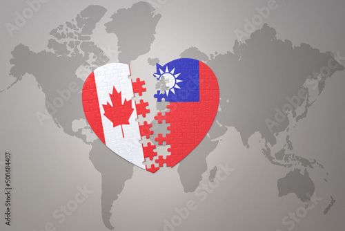 puzzle heart with the national flag of canada and taiwan on a world map background.Concept.