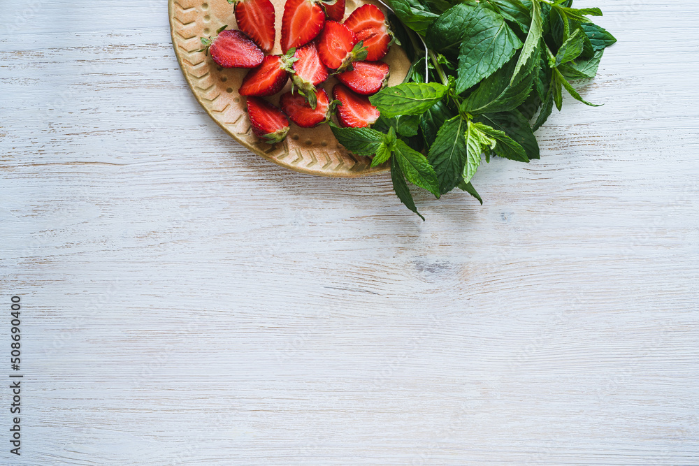Fresh organic local herb and berry fruit. Sliced strawberries and mint Fresh organic local herb and berry fruit. Sliced strawberries and mint