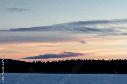 stunning sunset orange sky above trees in finnish lapland © Africa2008
