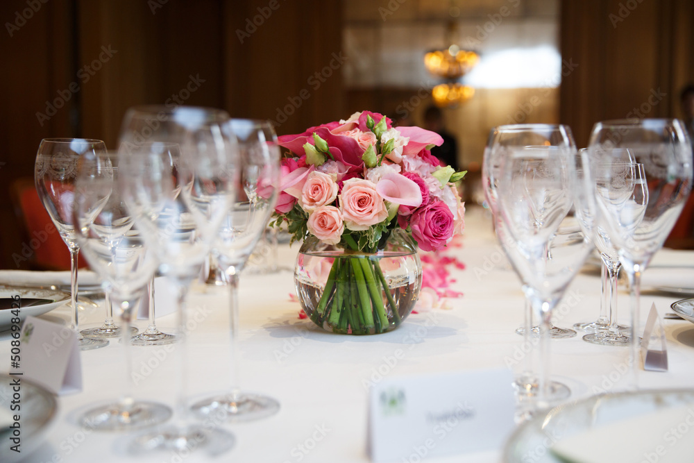 Bouquet of flowers in vase on the wedding table Bouquet of flowers in vase on the wedding table