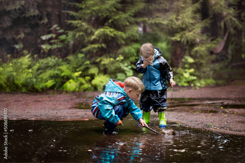 Картината върху платно Two little boys are playing in a muddle puddle