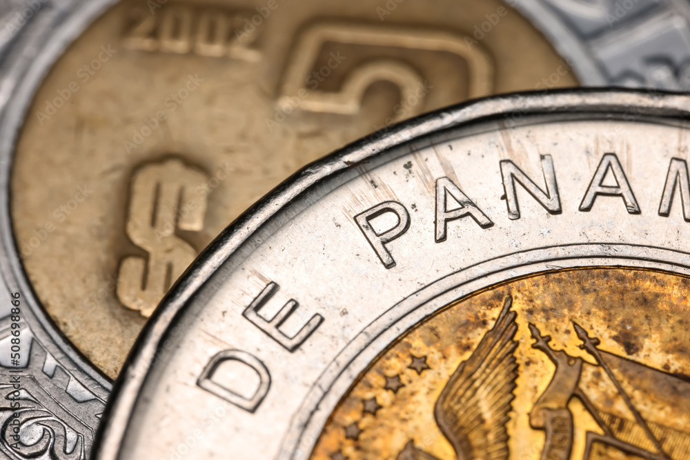 Close up shot of One Balboa bimetallic Republica de panama coin circa 2011. Mexican 2 peso coin is in the background.
