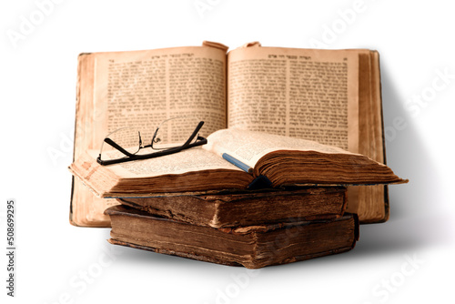 Obraz na płótnie Old worn shabby jewish books in leather binding and open blurred Torah in the background. Closeup. Selective focus. w salonie