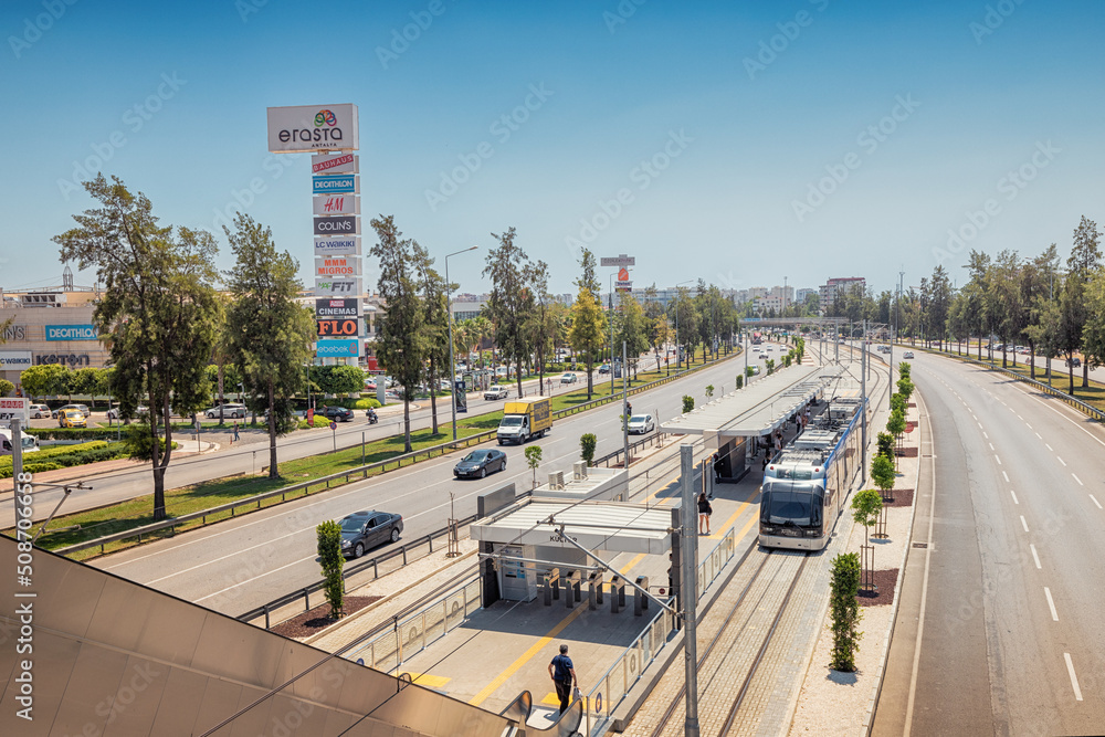 16 May 2022, Antalya, Turkey: Electric eco Antray tram driving parallel ...