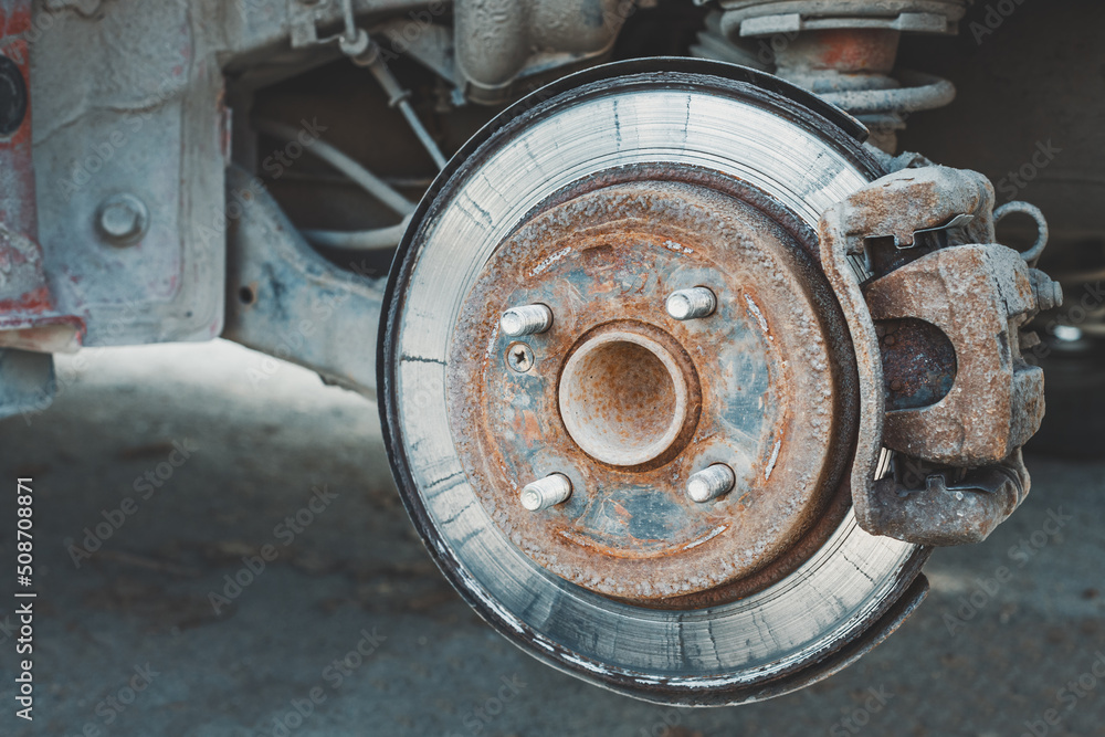 A rusty and old brake disc is serviced or replaced when the car is inspected by a mechanic. Safety and wear of the brake system A rusty and old brake disc is serviced or replaced when the car is inspected by a mechanic. Safety and wear of the brake system