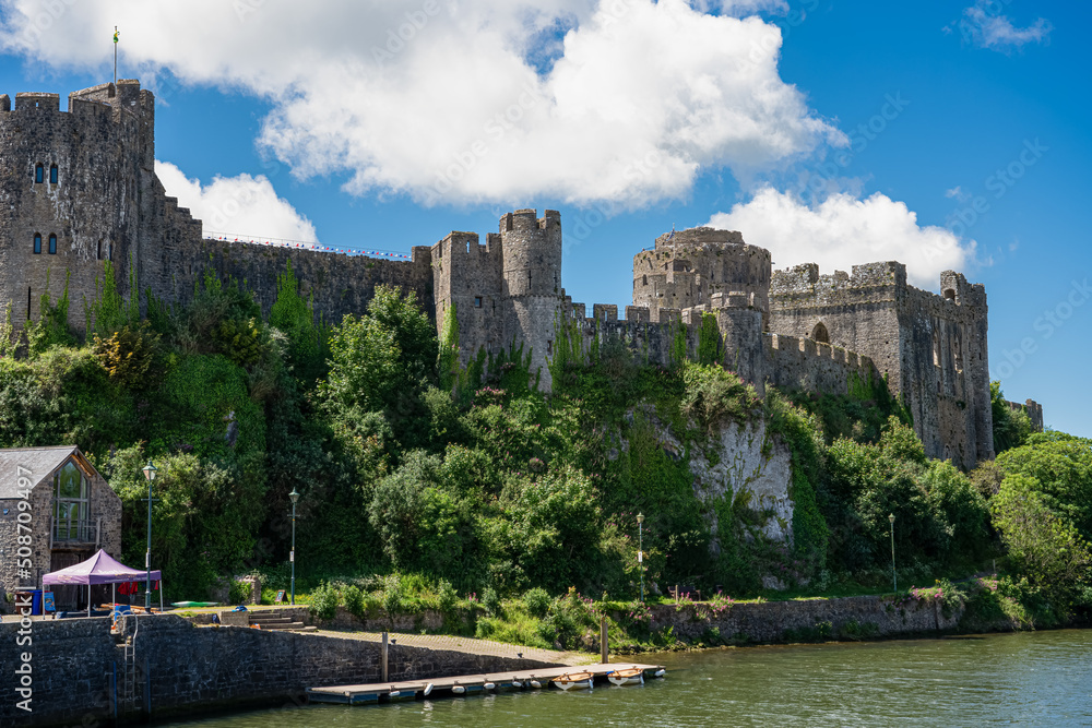 view of the stunning Pembroke Castle over Pembroke river, blue sky background view of the stunning Pembroke Castle over Pembroke river, blue sky background