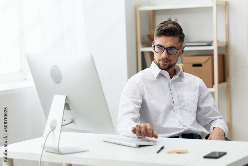 businessmen in a white shirt sits at a computer work documentation office businessmen in a white shirt sits at a computer work documentation office