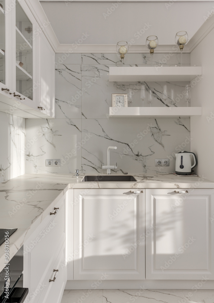 Sunshine in the bright, modern kitchen with kettle and white faucet Sunshine in the bright, modern kitchen with kettle and white faucet