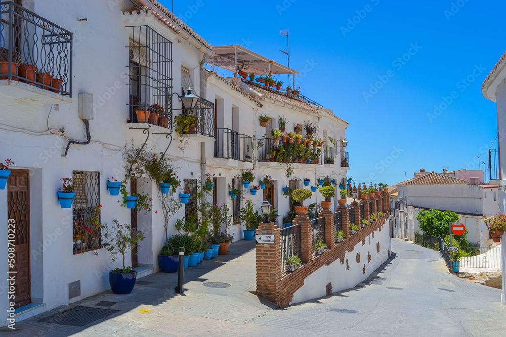 Fototapeta premium Mijas, Spain, 28.05.2022: narrow streets, balconies and decorated houses of the city in the mountains.
