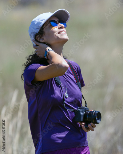 A woman photographs feliz in the forest of the cerrrado biome in west-central Brazil. Lifestyle. Nature photographer. Selective focus. photo