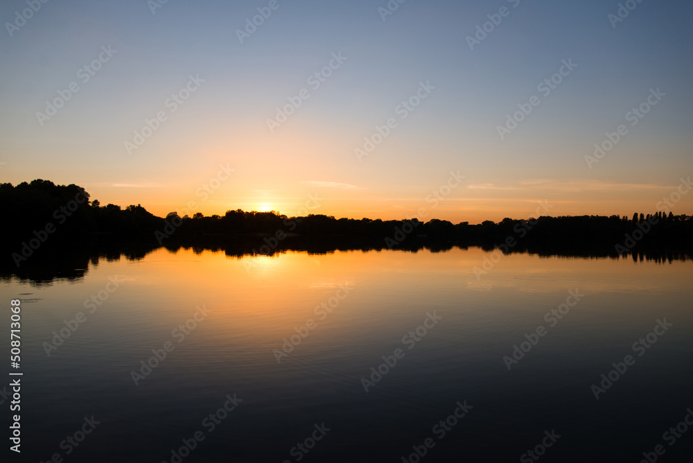 sunset over the river with reflection in the water