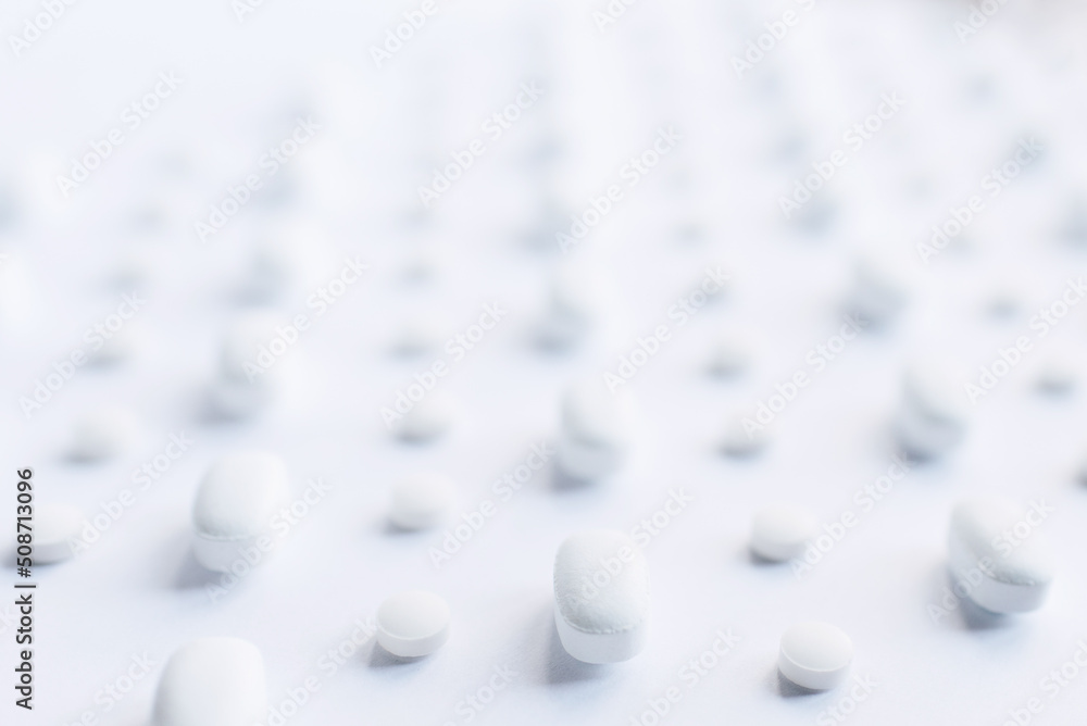 White pills on a white background. pills close-up. Healthcare and medicine. White pills on a white background. pills close-up. Healthcare and medicine.