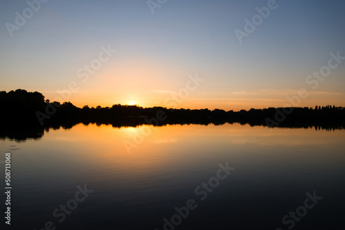 sunset over the river with reflection in the water