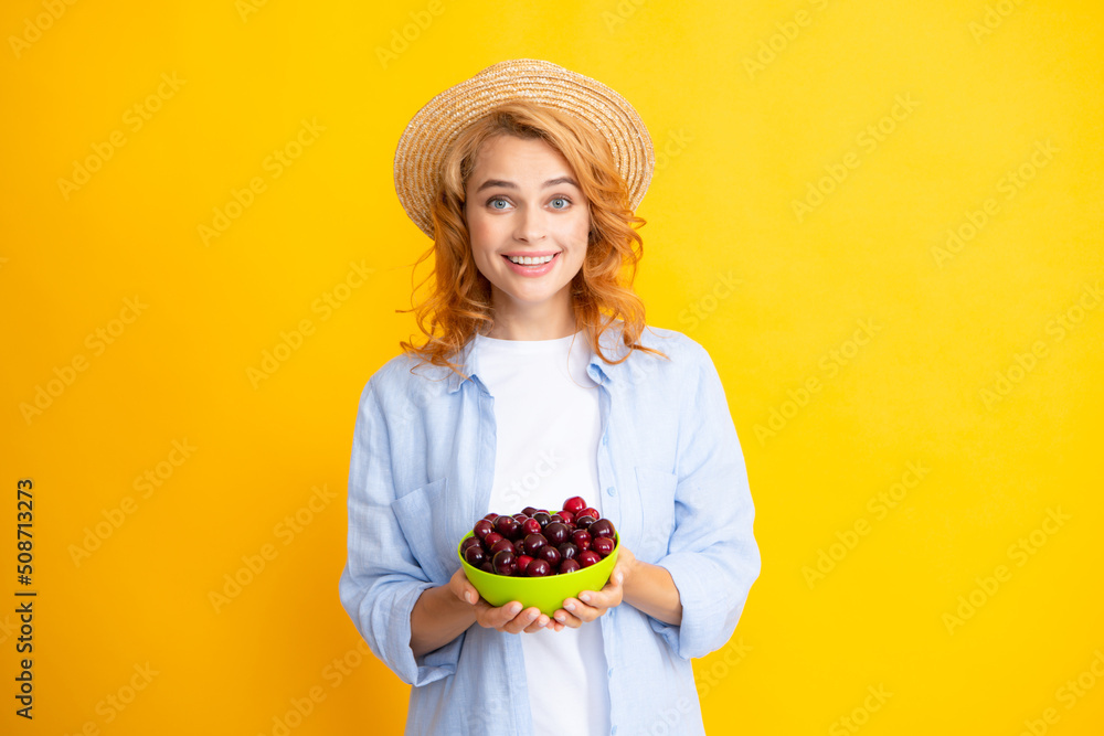Young stylish woman isolated holding red colorful cherries. Berries harvest season. Summer diet with organic harvesting cherry.