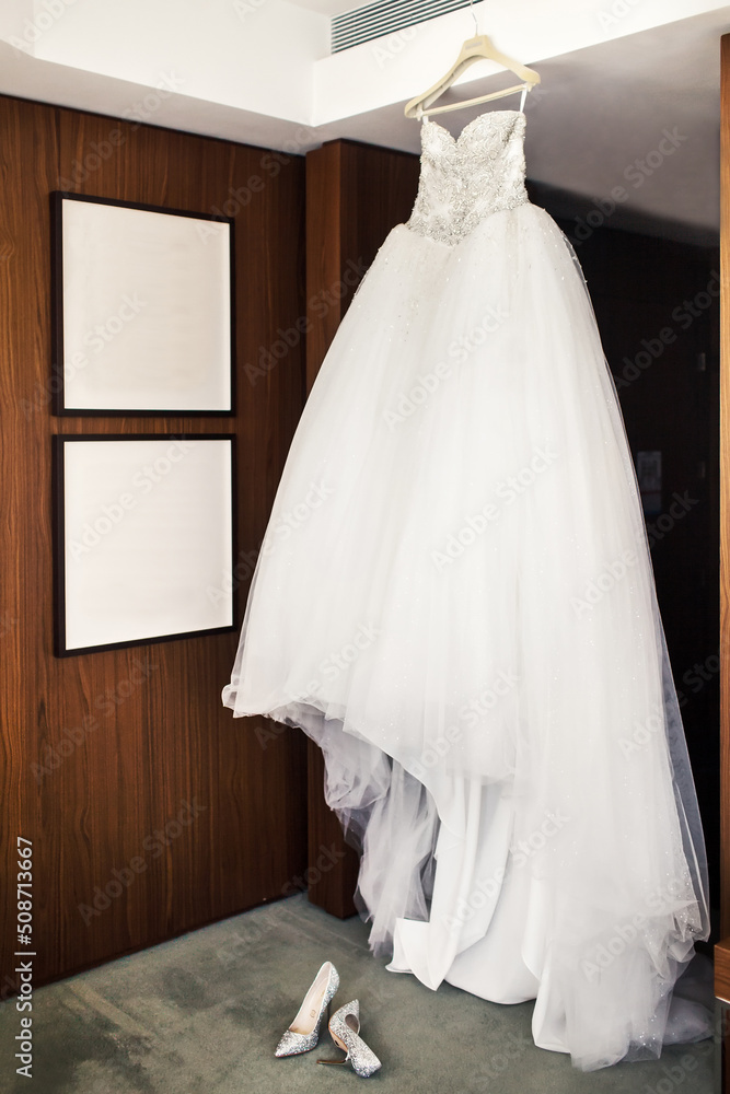Wedding dress in the room and shoes on a gray floor Wedding dress in the room and shoes on a gray floor