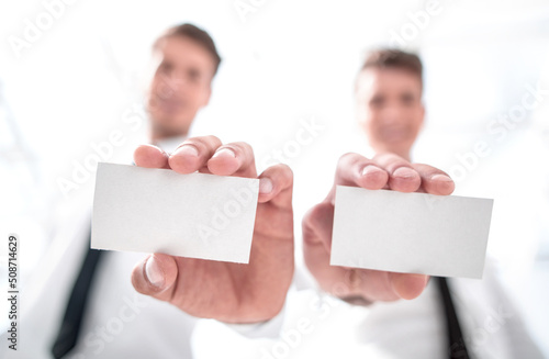 close up.blank business cards in the hands of business people. © ASDF