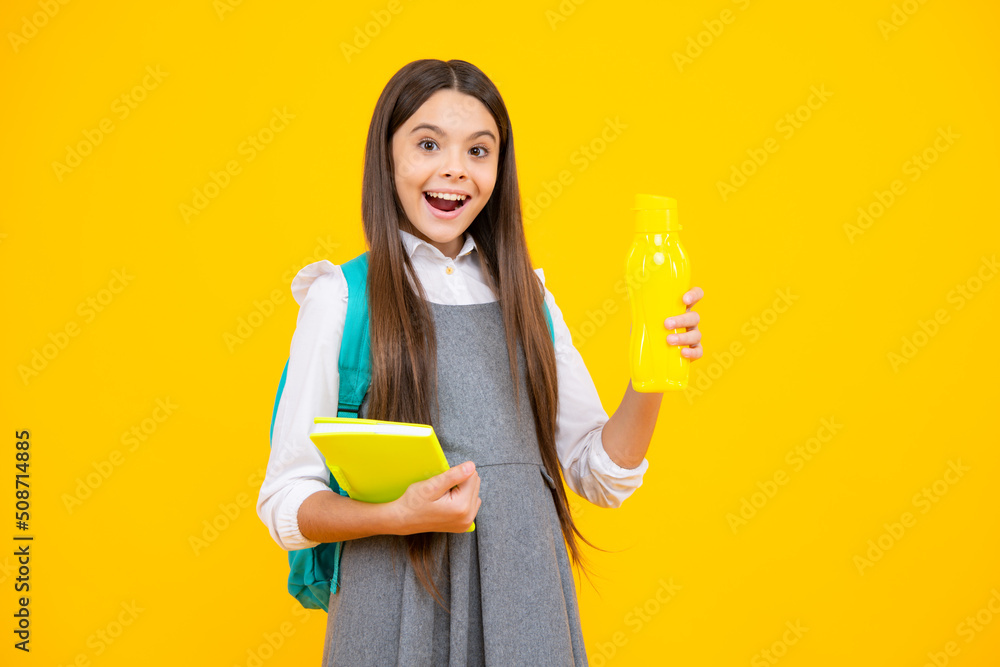 Excited face. Cute school girl with backpack holding water bottle. Amazed expression, cheerful and glad. Excited face. Cute school girl with backpack holding water bottle. Amazed expression, cheerful and glad.