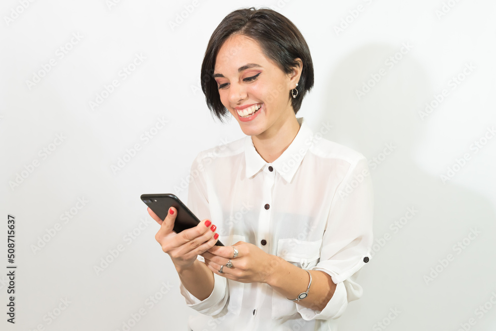 beautiful young latina girl, laughing and looking at her cell phone, very happy, shopping online, shopping concept. beautiful young latina girl, laughing and looking at her cell phone, very happy, shopping online, shopping concept.