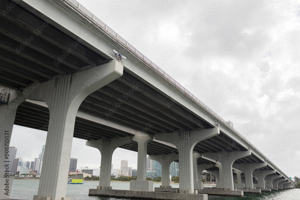 Large bridge seen from below with a cloudy sky in the background Large bridge seen from below with a cloudy sky in the background