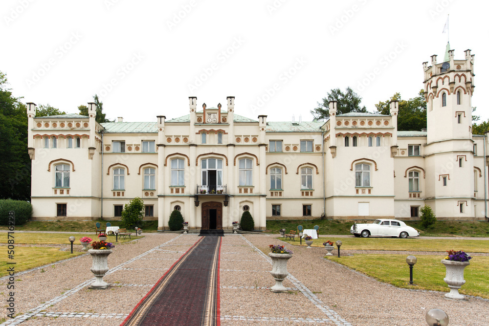 Fototapeta premium Exterior of a beautiful old house with white retro car