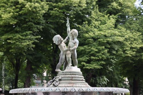 Two frolicking cupids angels figurines fountain in city center park square in Riga Latvia