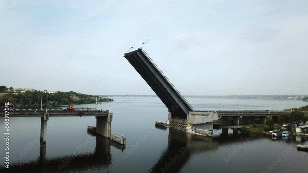 Fly by drone of a raised bridge for the passage of military carables along the river. Fly by drone of a raised bridge for the passage of military carables along the river.