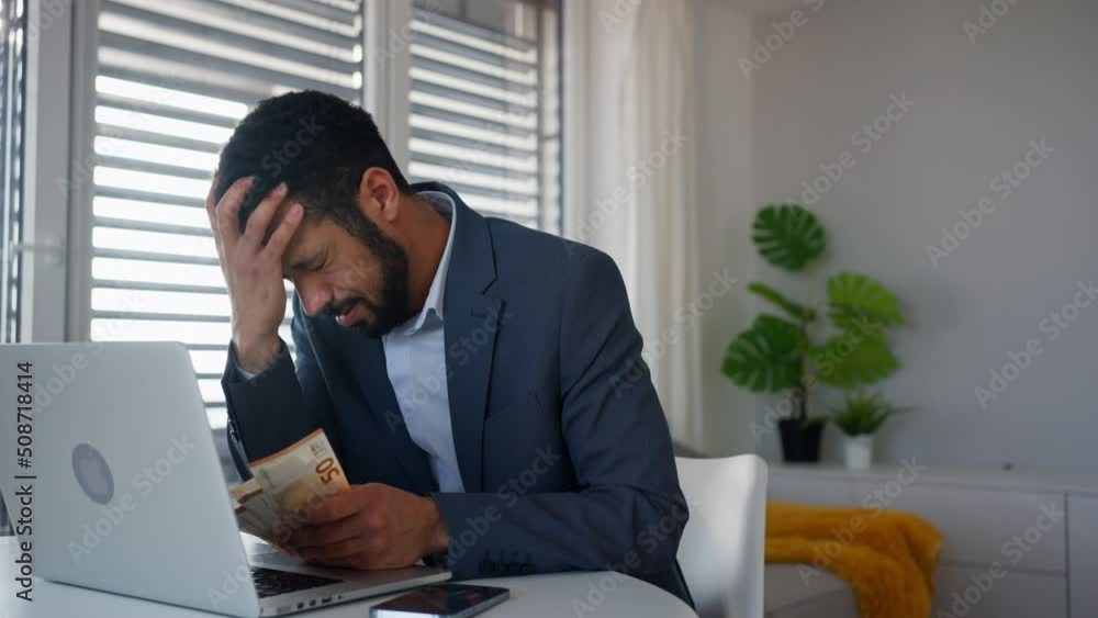 Depressed businessman man counting euro money working on computer at office desk, inflation concept. Depressed businessman man counting euro money working on computer at office desk, inflation concept.