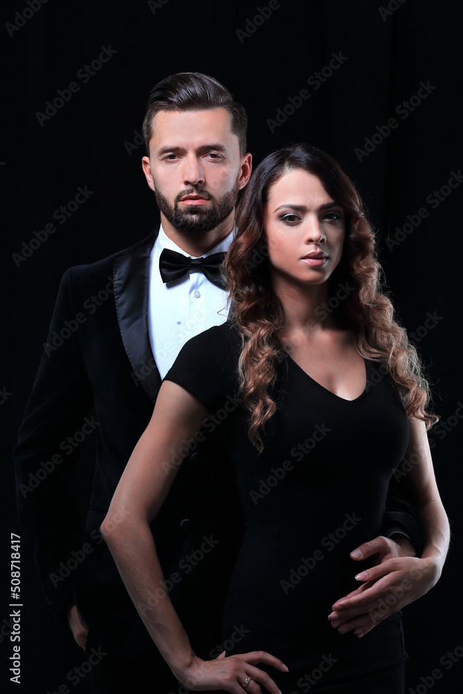 elegant man and woman posing next to each other on studio. elegant man and woman posing next to each other on studio.