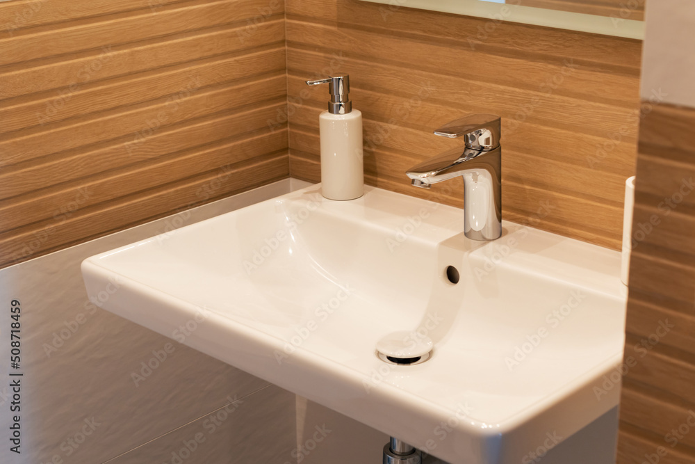 Sink with chrome faucet in a modern minimalist interior Sink with chrome faucet in a modern minimalist interior