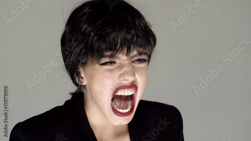Shouting mouth, screaming face. Young woman frustrated with rage, yelling mad photo