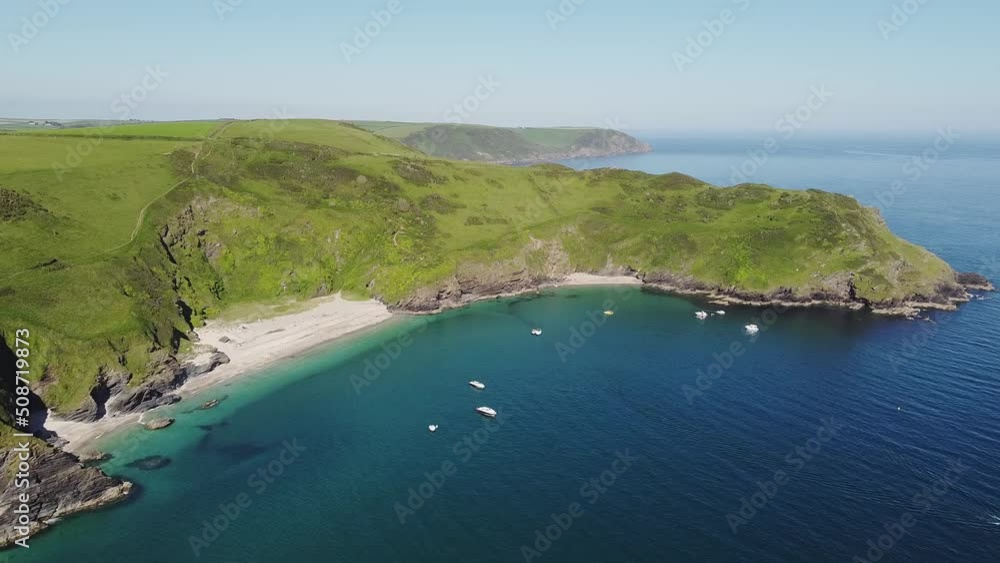Aerial view of the stunning coastline and beach at Lantic Bay. Crystal clear turquoise sea water in Cornwall, England. Aerial view of the stunning coastline and beach at Lantic Bay. Crystal clear turquoise sea water in Cornwall, England.