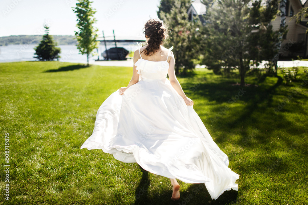 Bride in a beautiful dress is walking in the park Bride in a beautiful dress is walking in the park