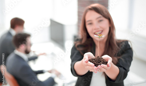 Bild auf Leinwand female environmentalist showing fresh sprout