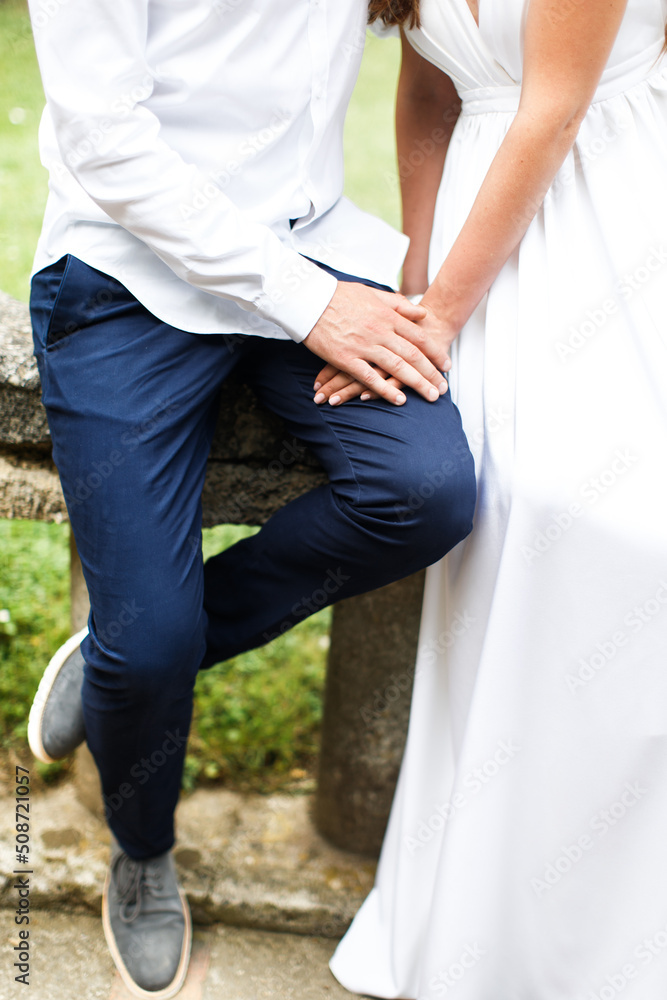Bride and groom holding hands in the park Bride and groom holding hands in the park