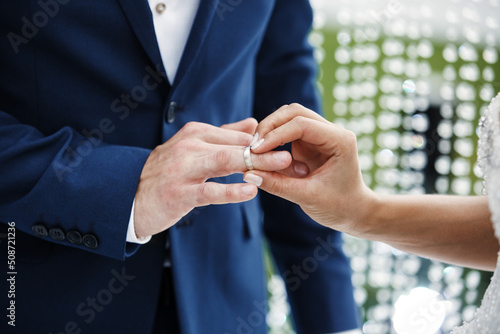 The bride wears a ring to the groom