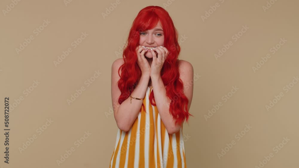 Panic attack. Upset scared frightened redhead woman biting nails ...